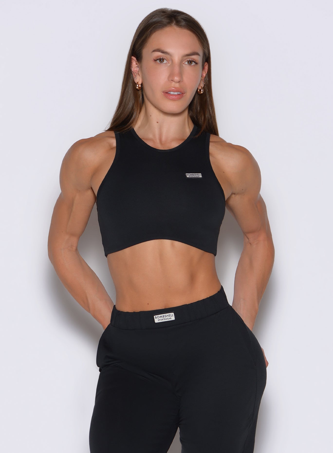 front profile view of a model wearing the Society Tank in black color
