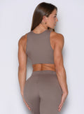 back side profile view of a model facing to the right side wearing the Society Tank in Espresso color
