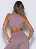 back side view of a model wearing the Society Tank in light mauve color