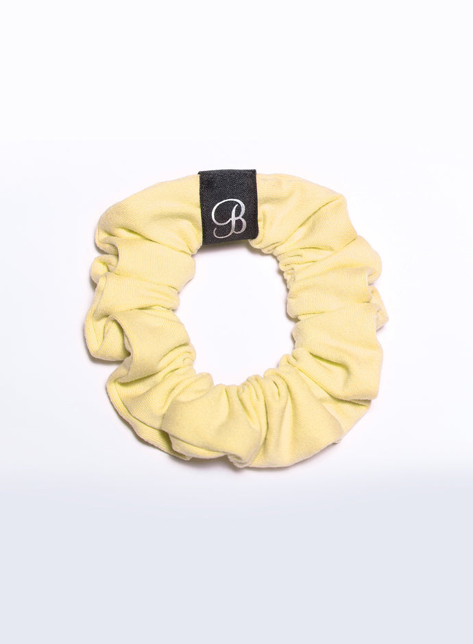 Picture of a scrunchie in soft yellow color 
