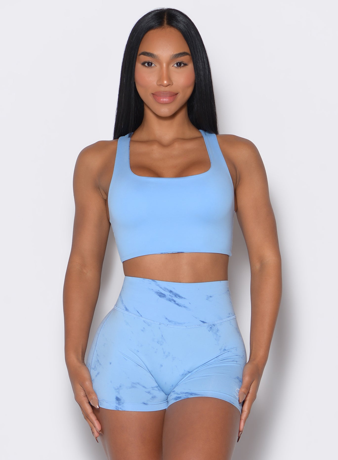 Front profile view of our model wearing the Square Neck Bra in Blue Jay color along with the matching shorts