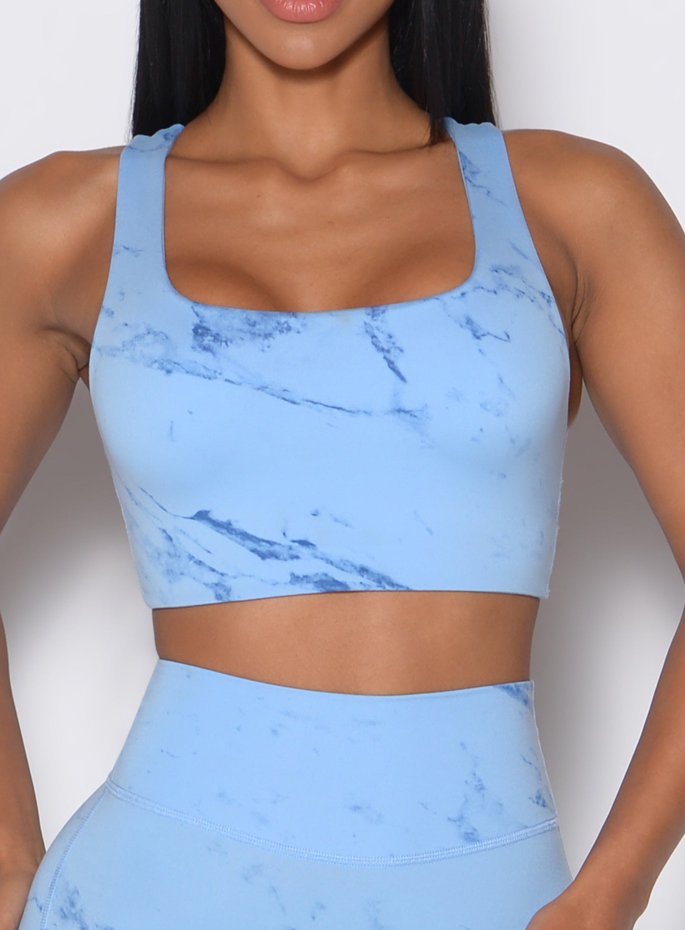 Zoomed in front profile shot of a model wearing the Square Neck Bra in Blue Jay color