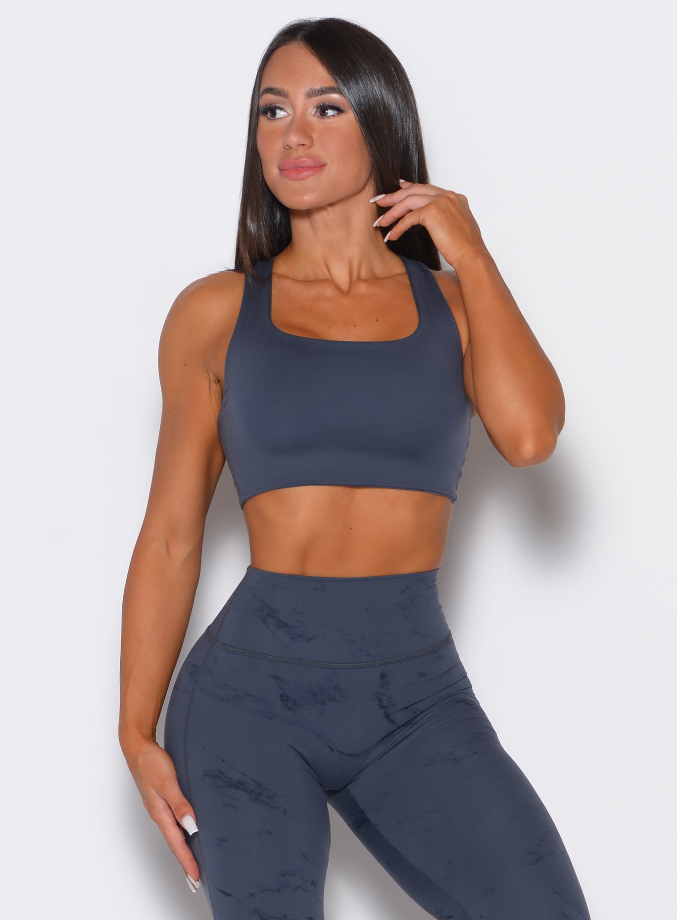 Front profile view of our model wearing the Square Neck Bra in Thunder Gray color along with a matching leggings