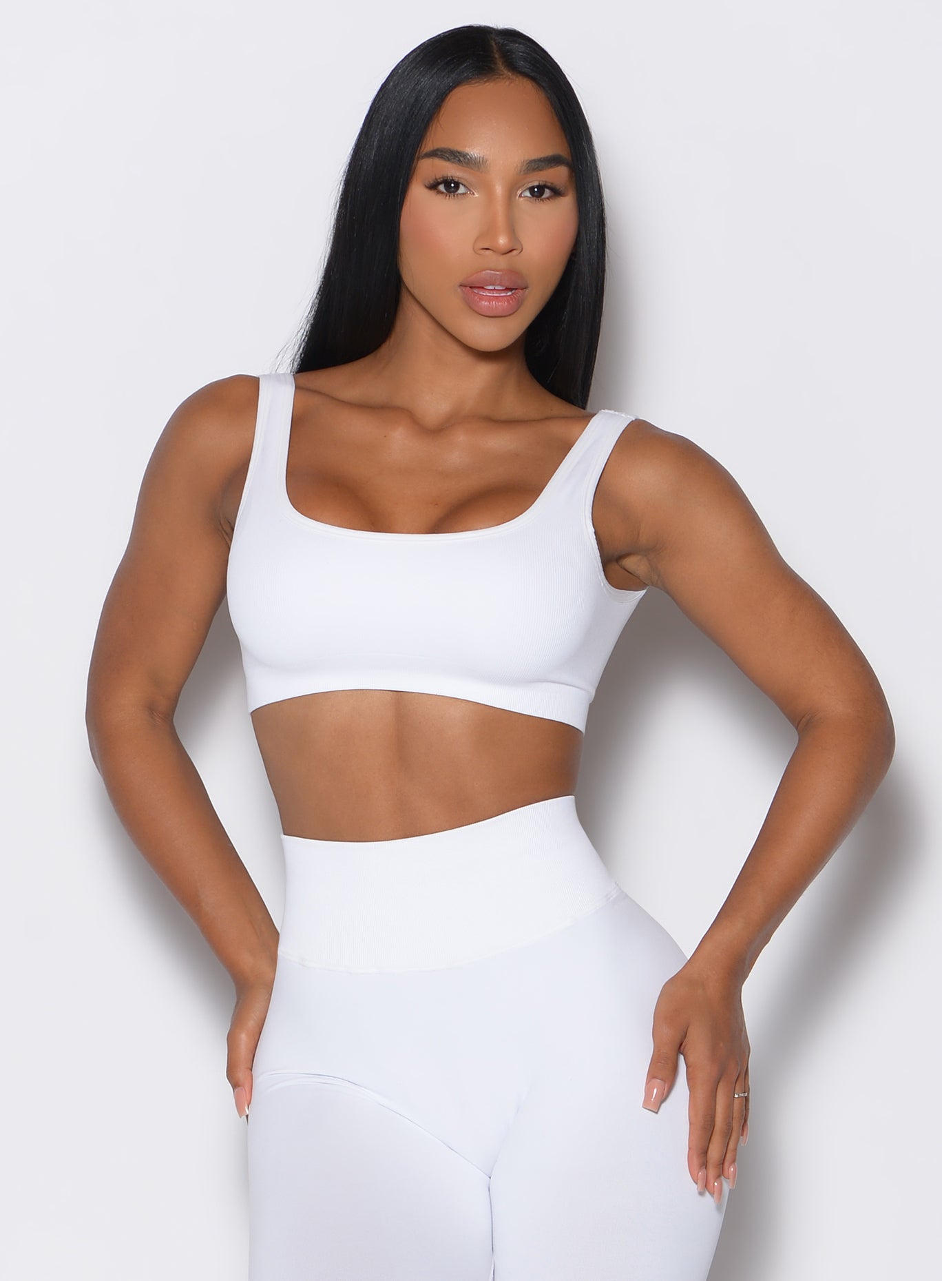 model facing forward wearing our white square neck bra along with a matching leggings 