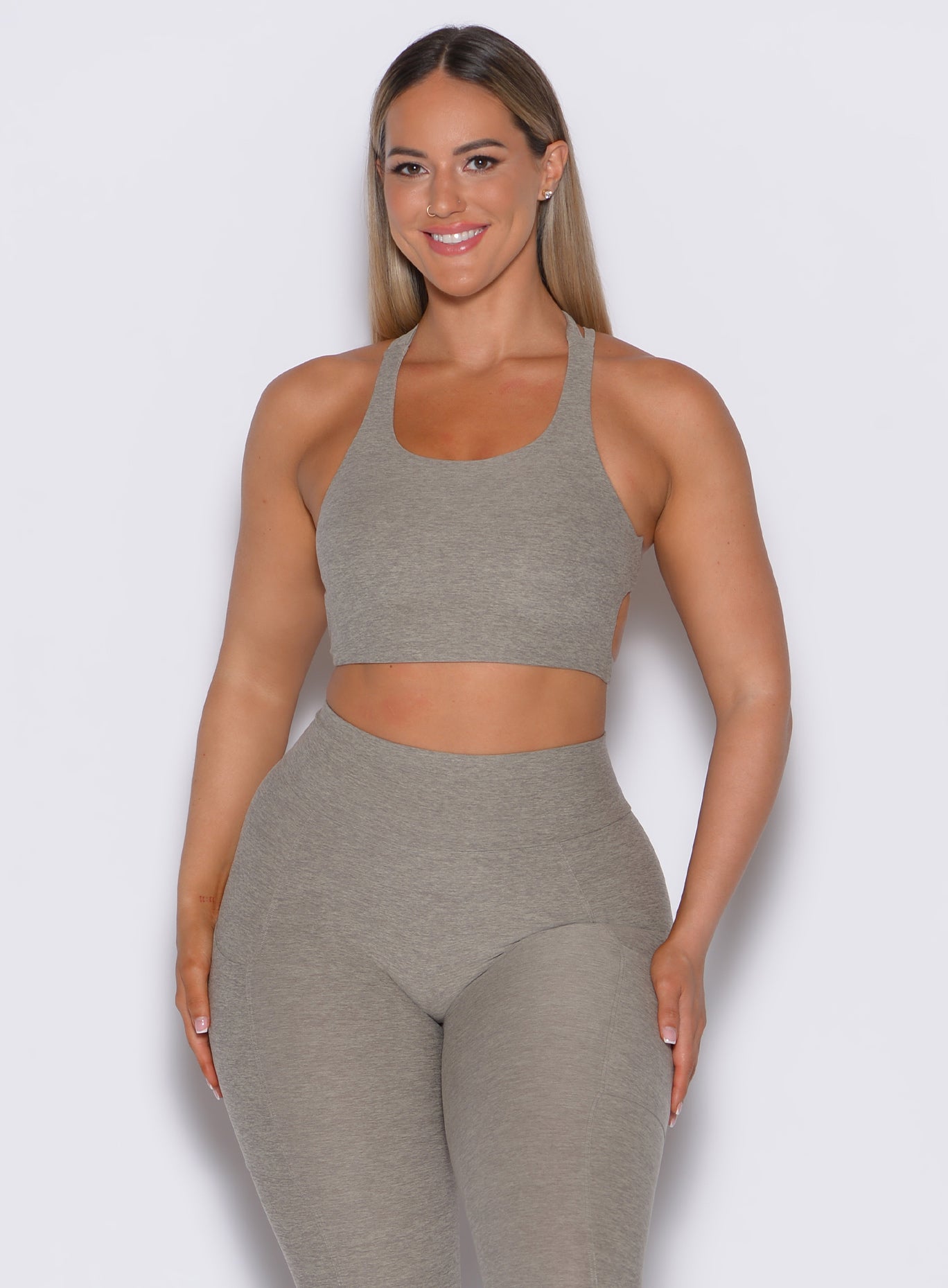 front profile picture of a model wearing our viral tank bra in nori color along with the matching leggings 