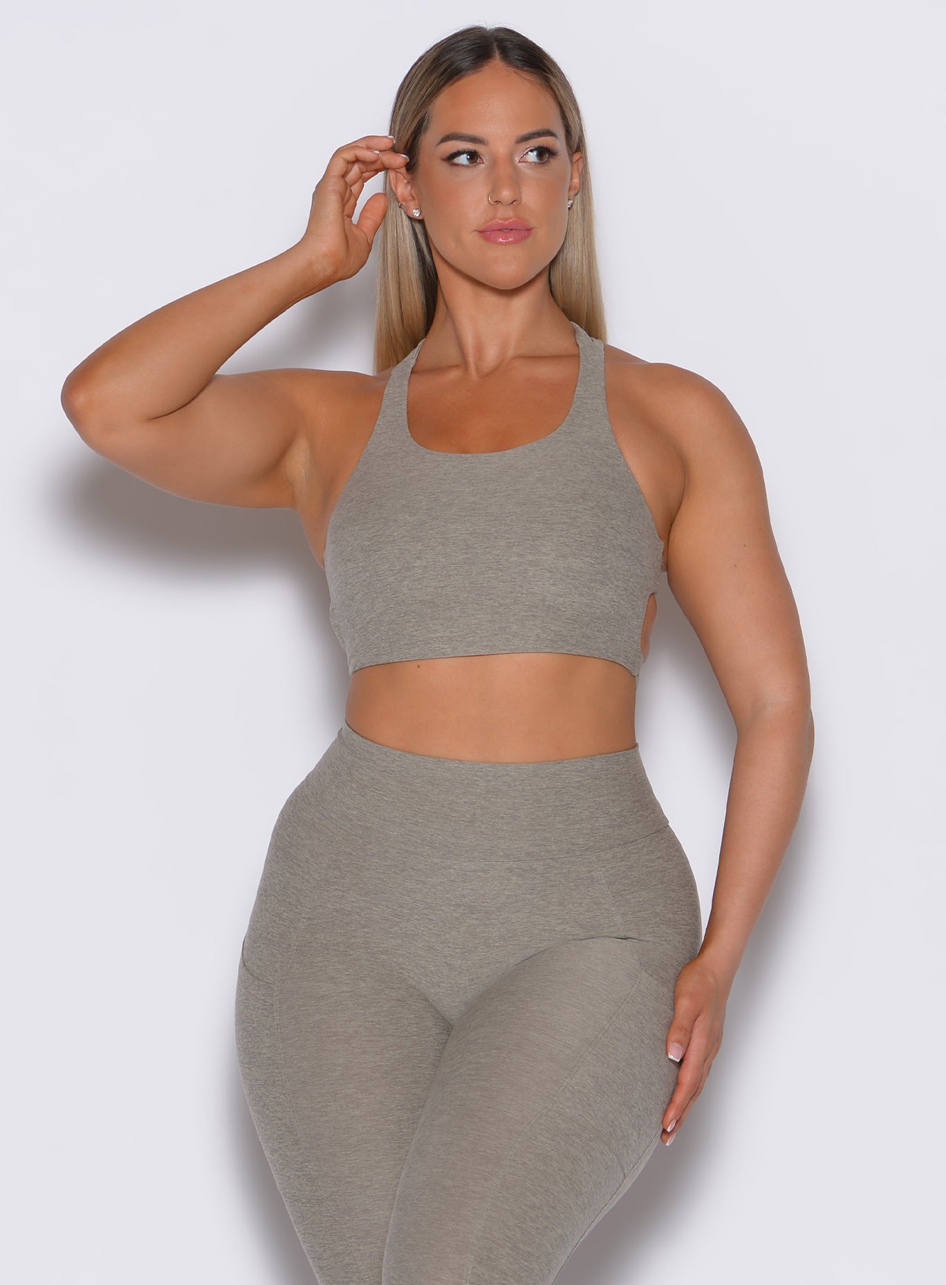 front profile picture of a model facing forward wearing our viral tank bra in nori color along with the matching leggings