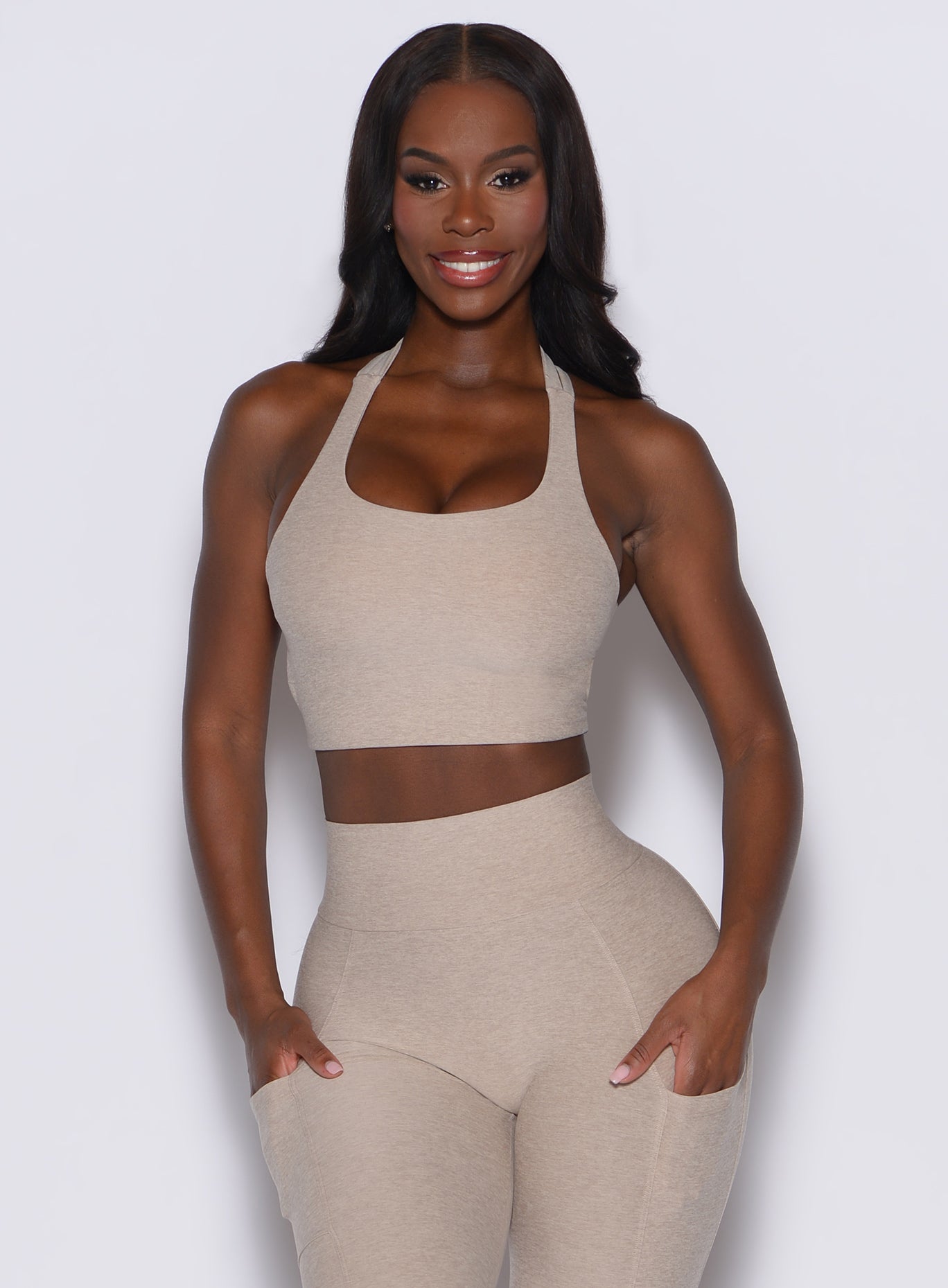front  profile picture of a model wearing our viral tank bra in taupe color along with the matching leggings