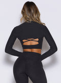 Studio Sculpt Bolero in Heathered Black; a sleek, thumbhole-cuffed layer for focused yoga flows.
