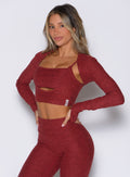 front left side view of a model with both hands on her waist wearing the Studio Sculpt Bolero in Rouge color