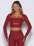 front view of a model with both hands resting on her thighs wearing the Studio Sculpt Bolero in Rouge color