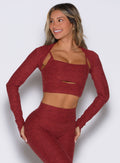 front profile view of a model facing to the right side wearing the Studio Sculpt Bolero in Rouge color