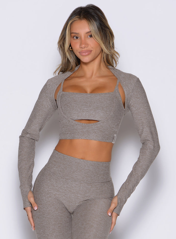 front view of a model with both hands on her thighs wearing the Studio Sculpt Bolero in smoked taupe color paired with the matching bra 