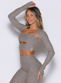 front left side profile view of a model with one hand resting on top of her head wearing the Studio Sculpt Bolero in smoked taupe color