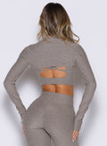 back side view of a model wearing the Studio Sculpt Bolero in smoked taupe color