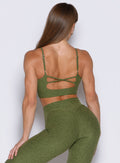 Juniper Studio Sculpt Bra in a rich forest green, featuring a sleek racerback for yoga sessions.
