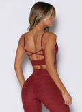 back profile view of a model facing to the right side wearing the Studio Sculpt Bra in Rouge color