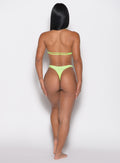 back profile of a back profile view of a model in our Sunkissed Sparkle Bikini Bottoms in Electric Lime color and the matching Sunkissed Sparkle Bikini Bra
