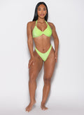 front profile view of a model wearing our Sunkissed Sparkle Bikini Bottoms in Electric Lime color and the matching Sunkissed Sparkle Bikini Bra