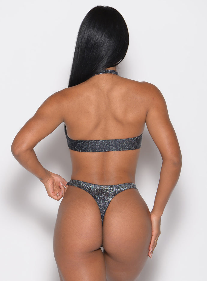 back profile view of a model wearing the Sunkissed Sparkle Bikini Bra in Black Diamond color paired with the matching bikini bottoms
