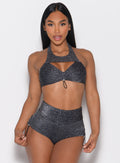front profile view of a model holding the side string of the shorts wearing the Sunkissed Sparkle Bikini Bra in Black Diamond color