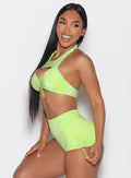 left side profile view of a model wearing the Sunkissed Sparkle Bikini Bra in Electric Lime color