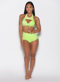 front profile view of a model wearing the Sunkissed Sparkle Swim Shorts in Electric Lime color paired with the matching bra