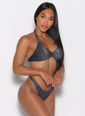 front right side profile view of a model holding hands in front wearing the Sunkissed Sparkle Bikini Top in Black Diamond color