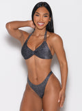 front profile view of a model wearing the Sunkissed Sparkle Bikini Top in Black Diamond color paired with the matching bikini bottoms