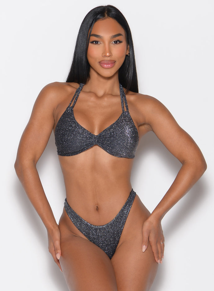 front profile view of a model with both hands on her thighs wearing the Sunkissed Sparkle Bikini Top in Black Diamond color