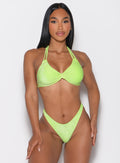 front profile view of a model with both hands on her thighs wearing the Sunkissed Sparkle Bikini Top in Electric Lime color