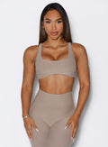 front view of a model with both hands on her thighs wearing the Super set bra in desert taupe color