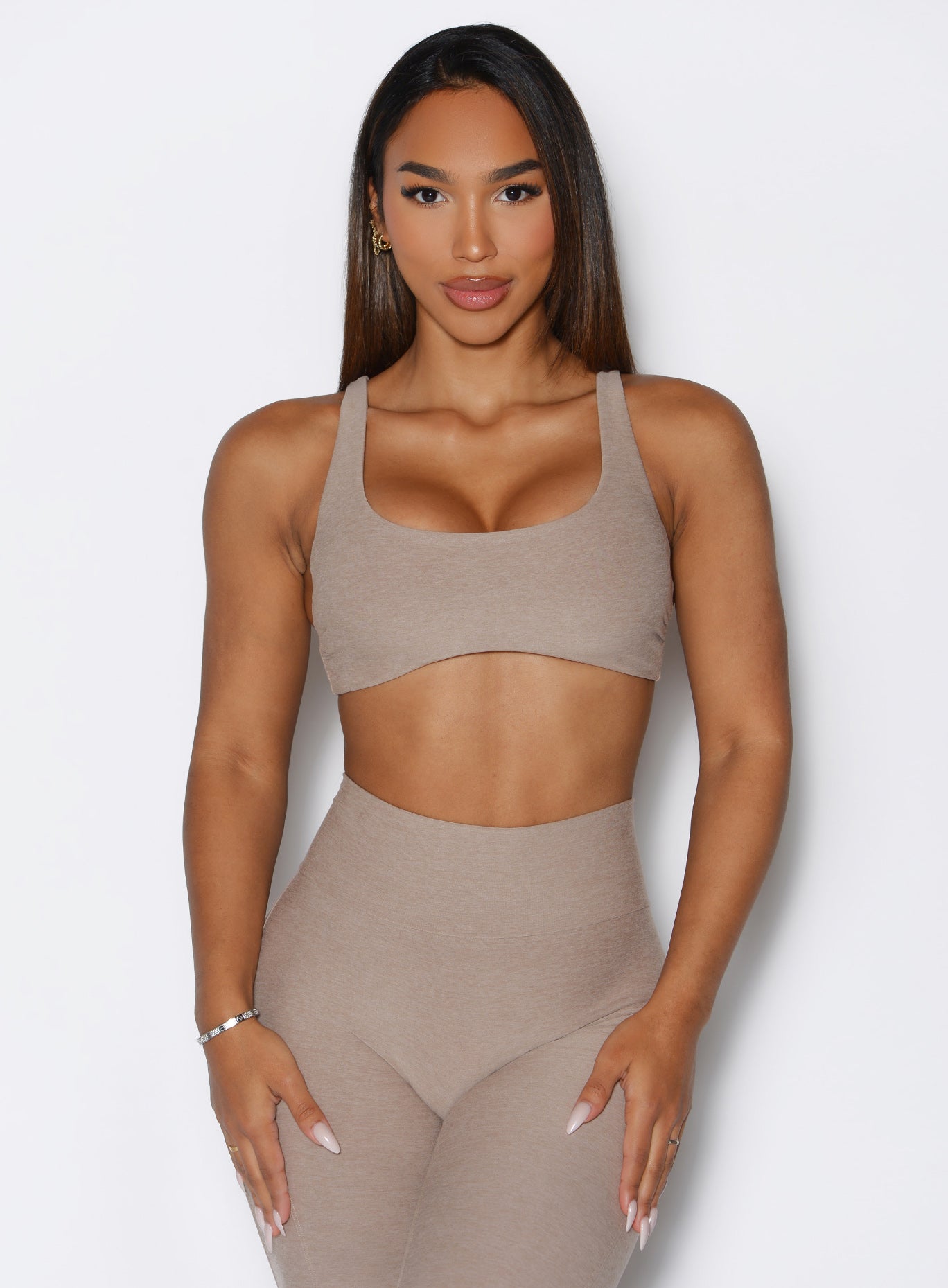 front view of a model with both hands on her thighs wearing the Super set bra in desert taupe color