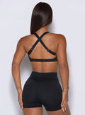 Rear angle highlights the adjustable racerback straps built for customized, high-impact gym support