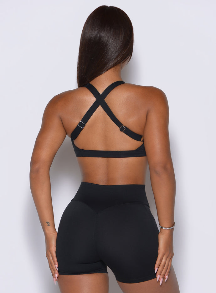 Rear angle highlights the adjustable racerback straps built for customized, high-impact gym support