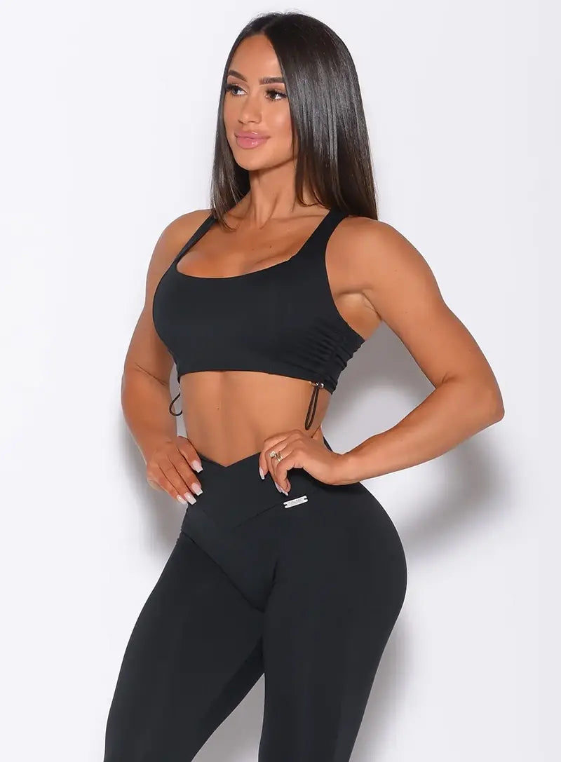 front view of model wearing a black bra and black leggings