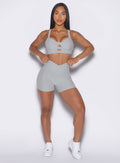 front profile view of a model wearing our tiny waist shorts in cloud color and the matching sports bra