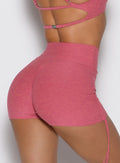 close up back profile view of a model wearing the Tiny Waist Tie Shorts in primrose color