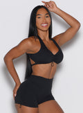 front right side profile view of a model wearing our Toggluxe Bra in black color