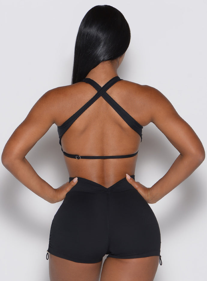 back profile view of a model with both hands on her waist wearing our Toggluxe Bra in black color