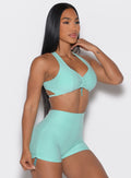 front right side profile view of a model wearing the Toggluxe bra in Oasis color