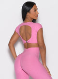 back right side profile view of a model wearing the Toggluxe Tee in Bubblegum color