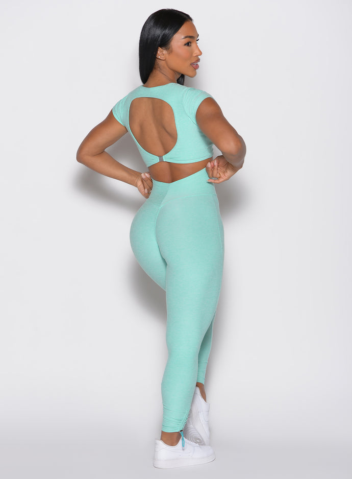 back right side profile view of a model wearing the Toggle Pull Leggings in Oasis color