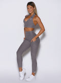 front left side view of a model wearing the Toned 7/8 Leggings in Champion Gray color