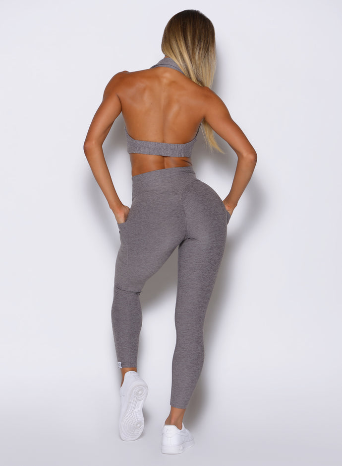 back profile view of a model wearing the Toned 7/8 Leggings in Champion Gray color