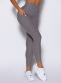 close up right side view of a model wearing the Toned 7/8 Leggings in Champion Gray color