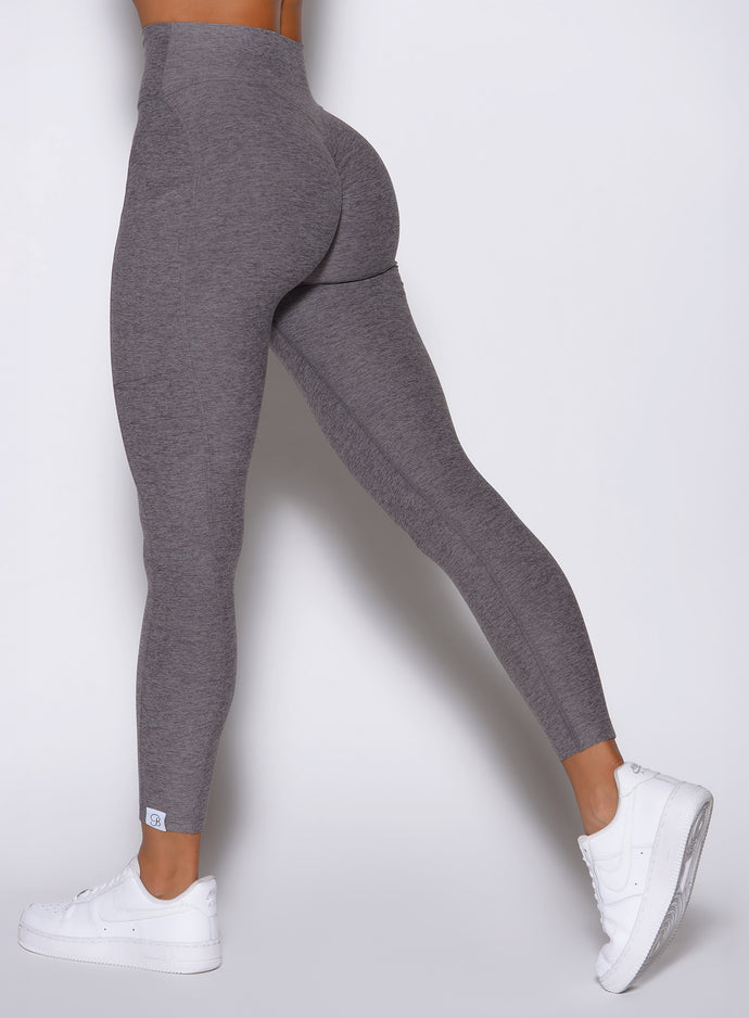 close up left side view of a model wearing the Toned 7/8 Leggings in Champion Gray color