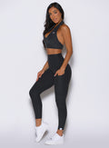 left side profile view of a model wearing the Toned 7/8 Leggings in Charcoal color