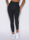 zoomed in frontal view of a model wearing the Toned 7/8 Leggings in Charcoal color
