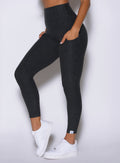 close up left side view of a model wearing the Toned 7/8 Leggings in Charcoal color