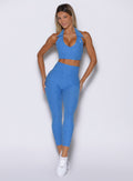 front profile view of a model wearing the Toned 7/8 Leggings in Legacy Blue color